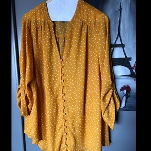 Polka dot yellow blouse with buttons.